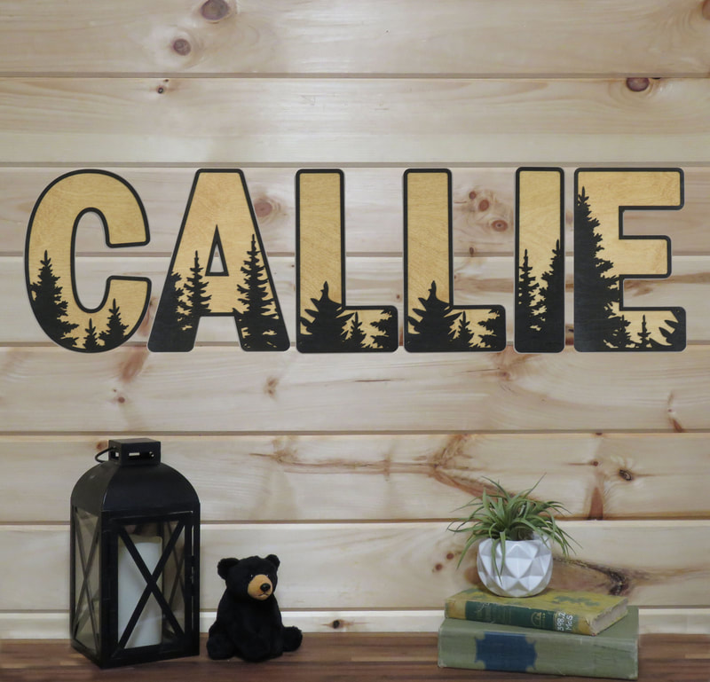 Handmade wood letters with tree silhouettes decor for cabin or nursery.
