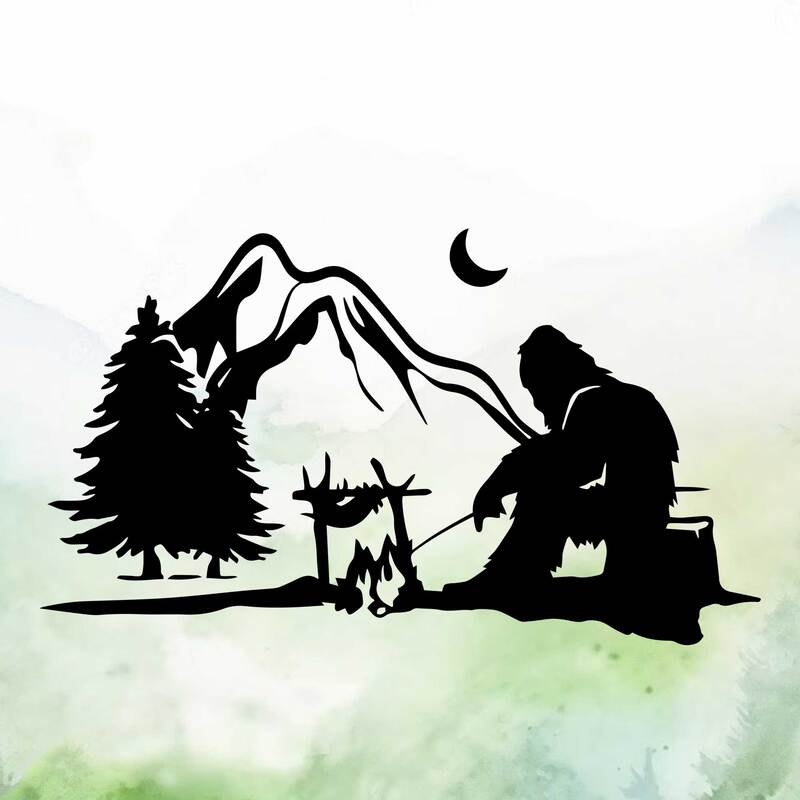 Silhouette of bigfoot roasting dinner over campfire in front of mountains.