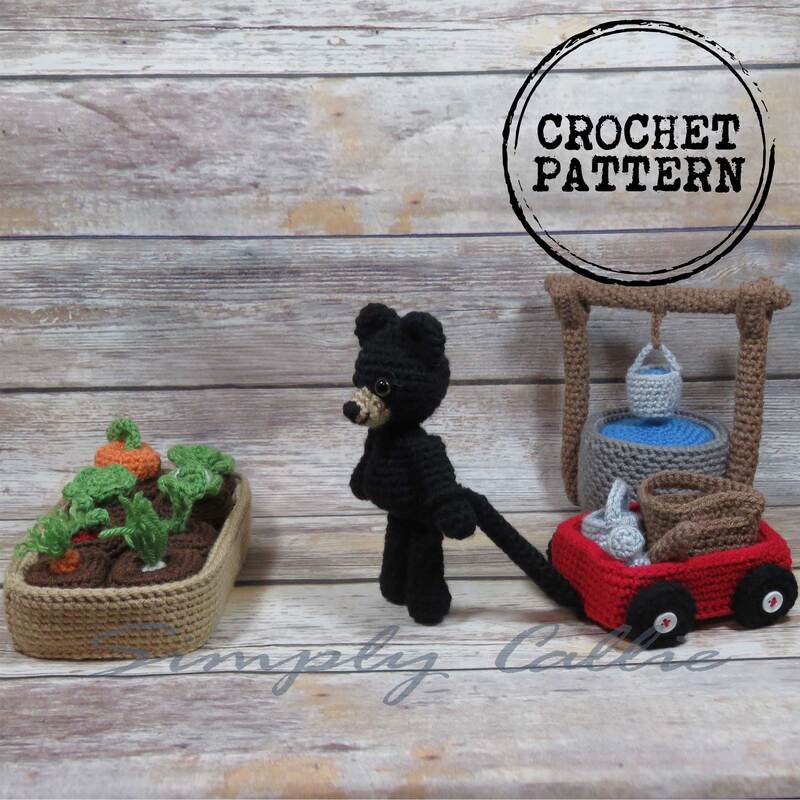 Crochet garden pattern playset that includes raised garden bed with vegetables, water well with bucket, little red wagon and garden tools.