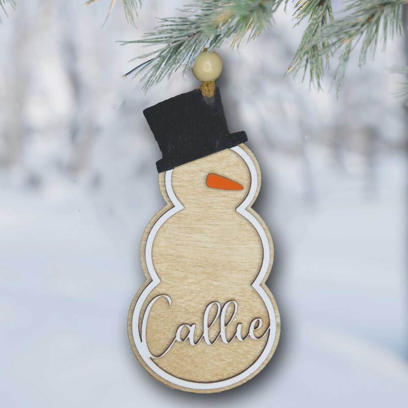 Personalized wood snowman Christmas ornament.